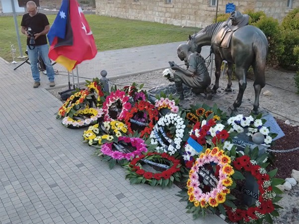 Wreaths laid at base of Semakh sculpture